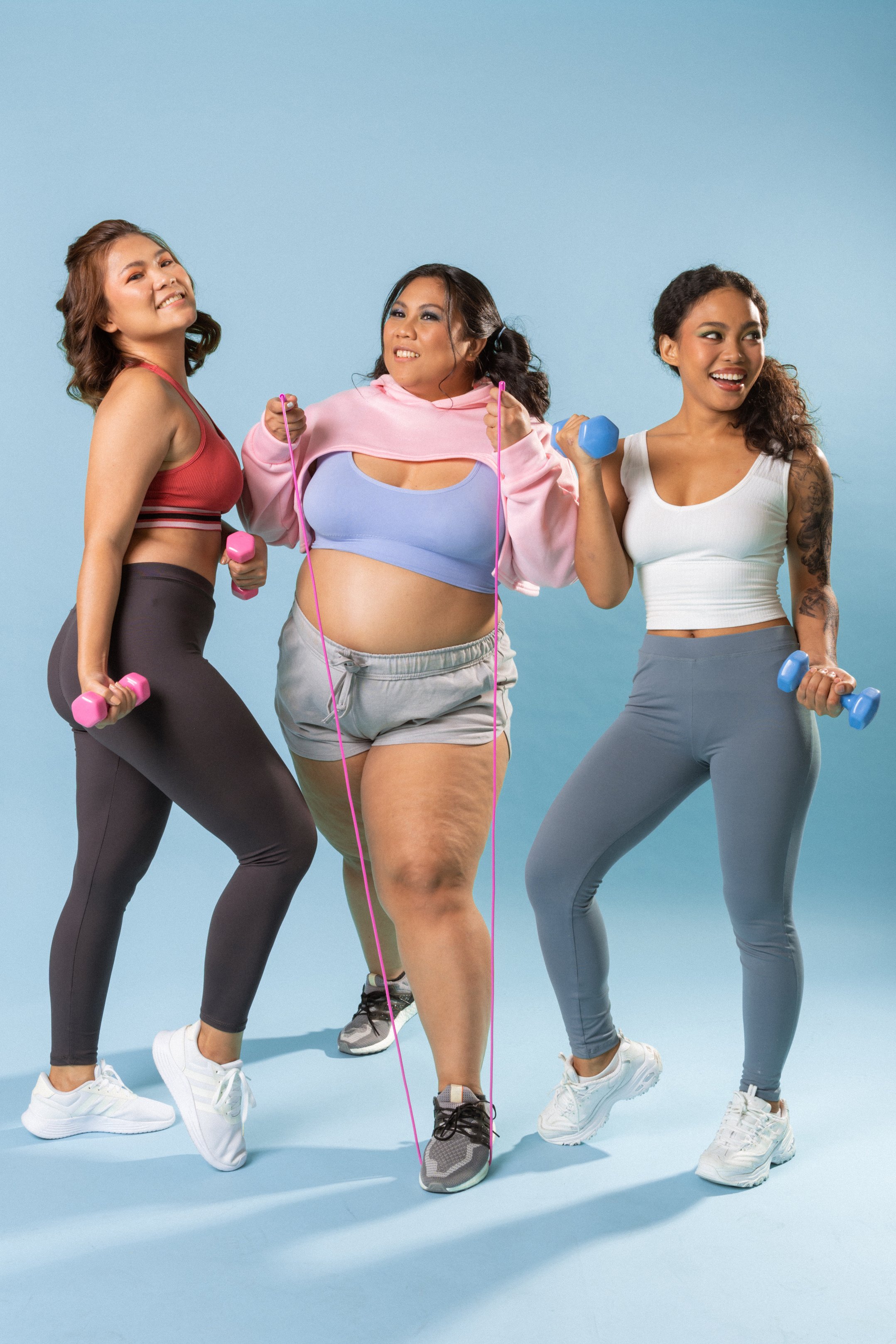 Women in Activewear Exercising on Blue Background